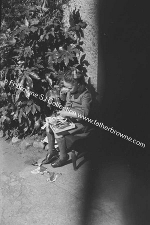 CHILD PLAYING ON DOORSTEP